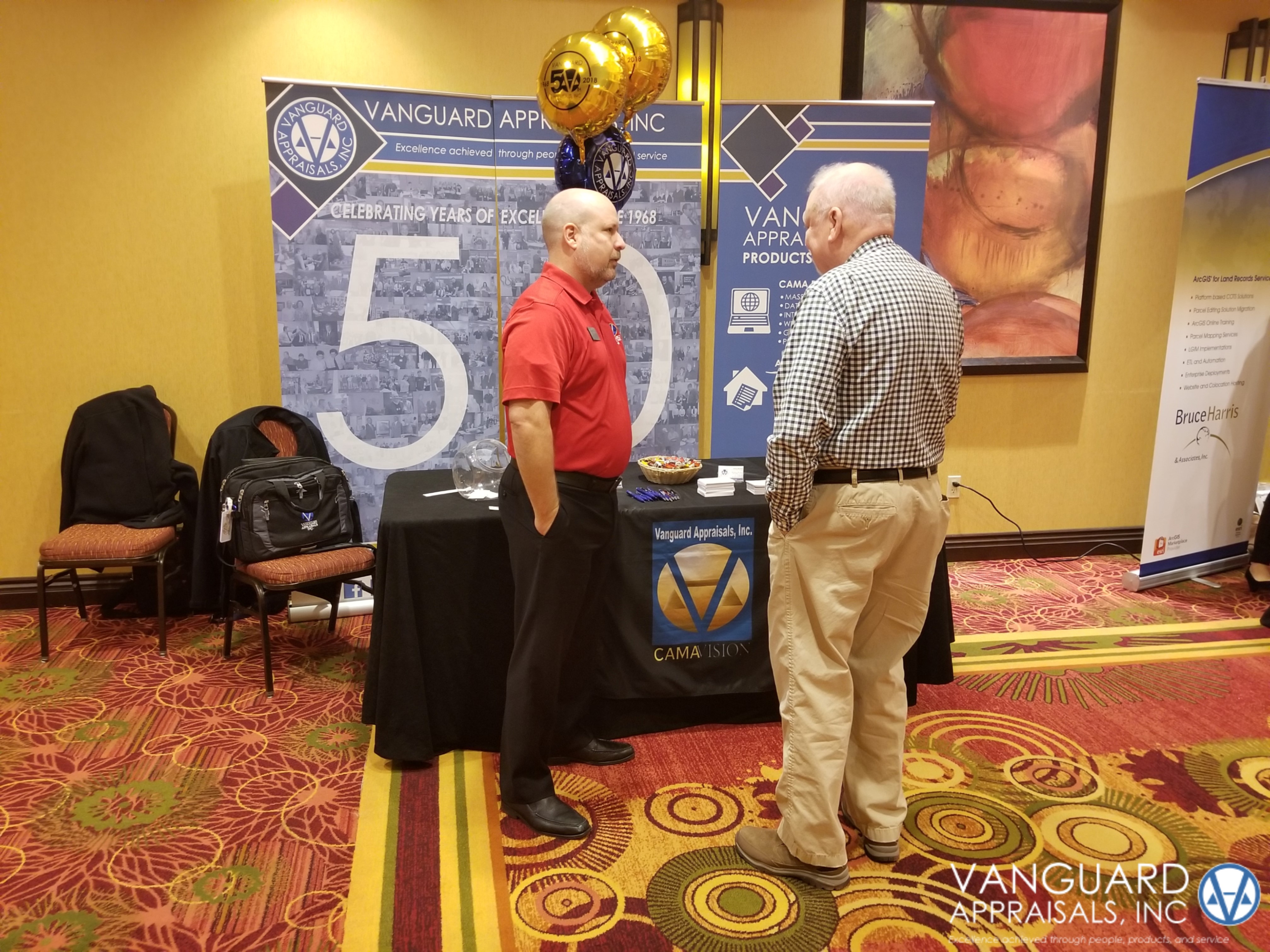 Vanguard Appraisals Regional Manager Mike Weeks talking with an IPAI Conference attendee.